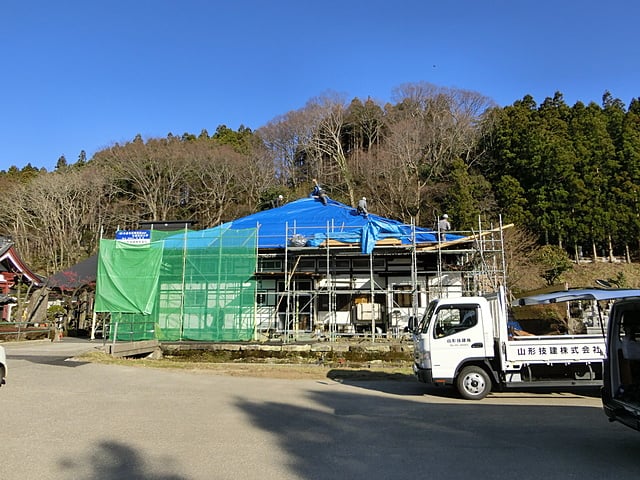 屋根板の張り終わった面をシートで養生しています。